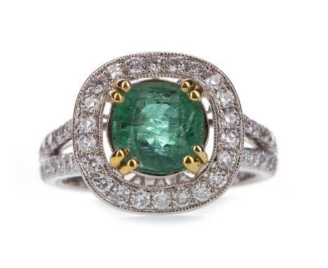 EMERALD AND DIAMOND RING, the cushion shaped emerald of approximately 1.88 carats, within a diamond halo, on bifurcated diamo