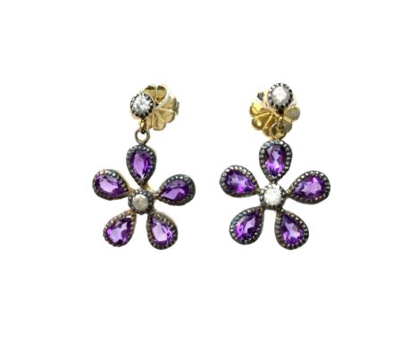 PAIR OF AMETHYST AND DIAMOND EARRINGS, in the form of a flower, each with a central round brilliant cut diamond surrounded by