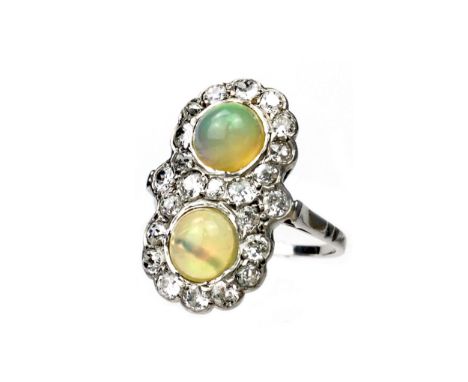 OPAL AND DIAMOND RING, set with two cabochon opals within a border of old cut diamonds, the diamonds totalling approximately 