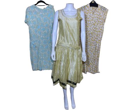 mostly 1960s clothing to include a pink house coat with autumn leaves, a yellow and white floral cotton dress, a Horrockses l