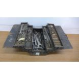 A metal cantilever toolbox with a quantity of tools including wrenches, spanners, sockets, etc.