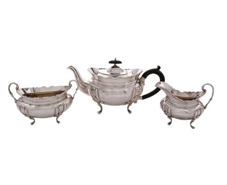 A George V silver three piece silver teaset, maker Hawksworth, Eyre and Co Ltd, Birmingham 1934, of barge shape, with embosse