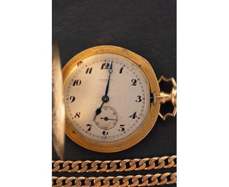 An 18ct gold Edwardian hunter pocket watch with chain the movement having a lever escapement with the silvered dial having bl