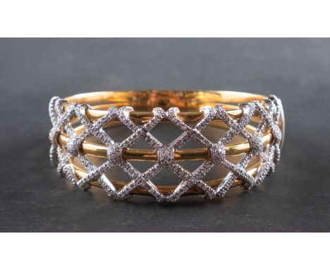 A mid-20th century, diamond-set, hinged bangle, of lattice design, with Italian control marks for 18ct gold, total estimated 