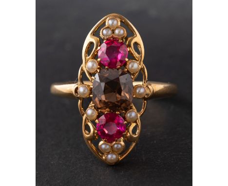 An 18ct gold, brown zircon, synthetic ruby and seed pearl openwork ring, the shank with hallmarks for Chester, 1906, length o