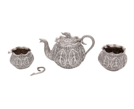 An Indian three piece silver bachelor's tea set, unmarked, possibly Madras, chased figures of deities, snake handles, elephan