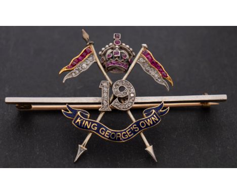 A 19th King George V's Own Lancers Regimental Badge, set with mixed-cut rubies and diamonds, total estimated diamond weight c