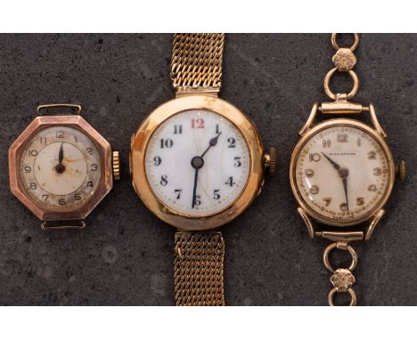 A small 15ct gold wristwatch the white dial with black and red Arabic numerals and blued-steel spade hands, the rear engraved
