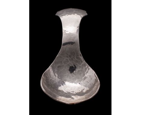 An Arts and Crafts hammered caddy spoon, white metal, with flared handle, stamped KSIA, 8cm long.