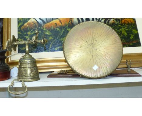 A Victorian bronzed figure / table lamp; a wall hanging gong; a brass wall hanging bell etc