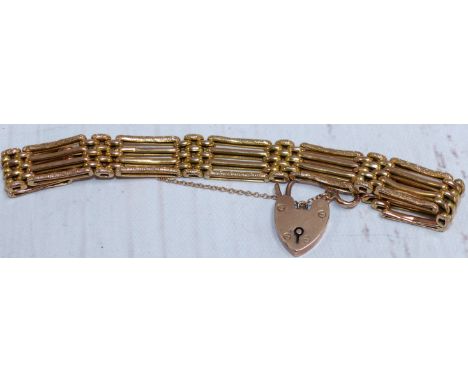 An antique 4 bar gate bracelet with padlock and safety chain, stamped '9CT', 13.6 gm