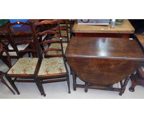 A 19th century oak drop leaf dining table on barley twist legs, and 6 (4 + 2) oak ladder back chairs