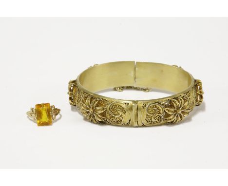 A silver gilt filigree hinge bangle, with applied flowers and a 9ct gold single stone paste ring with bow shoulders, size O r