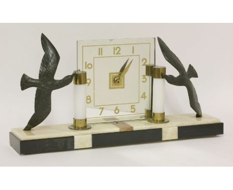 An Art Deco table clock,the mirrored dial flanked with lights and seagulls on a marked onyx plinth,52cm wide