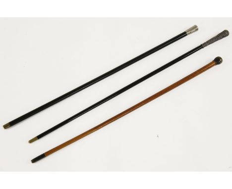 Three walking sticks, the first with regimental crest The Lancashire Fusiliers, the second with Indian type decoration, the t