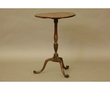 An Edwardian mahogany circular tilt top table on tripod base, the top inset with a commemorative coin, 41cm high and 60cm wid