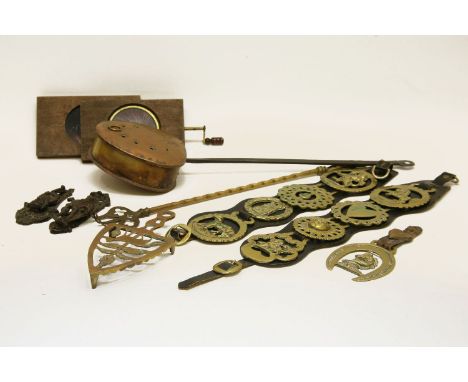 A 19th century copper chestnut roaster, and toasting fork, together with a collection of horse brasses and similar