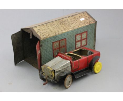 Vintage tin plate Brenco car (a/f with repair) within a tin plate engine shed