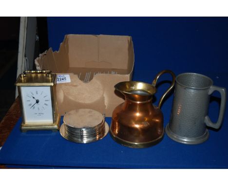 A Pewter Tankard, brass/copper pitcher, small plated Salver, set of coasters and a small Brass carriage Clock