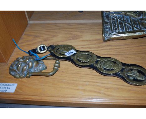 Four horse brasses on leather strap and a Brass Door Knocker