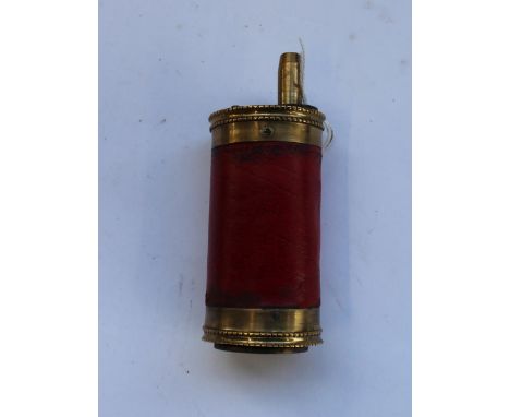Circular pistol powder flask with red leather cover 
