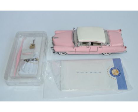 A Franklin Mint 1/24 Elvis Presley 1955 Pink Cadillac diecast model car, with box, paperwork and all accessories including th