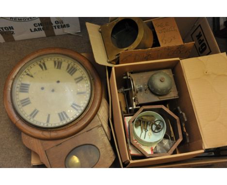 A box containing a collection of clock parts, cases and movements including drop dial, postman's alarm and brass cased