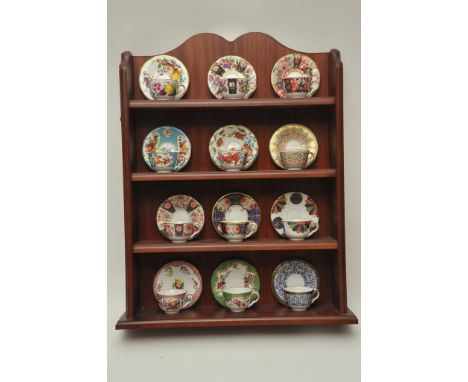 12 Worcester miniature cups and saucers, on a display stand 