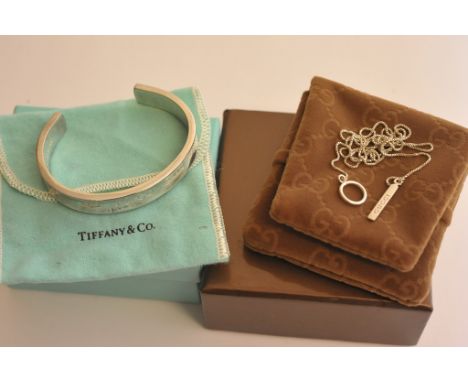 A boxed Tiffany silver bangle and Gucci necklace