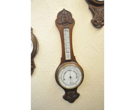 A similar carved oak wall barometer 
