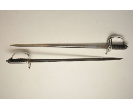 A pair of miniature Wilkinson dress swords with engraved blades