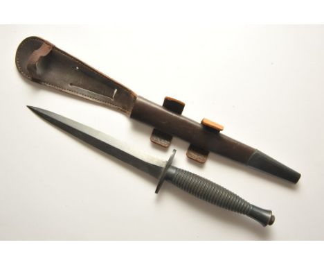 A WWII Commando dagger with leather scabbard