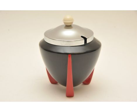 An Art Deco Wilkinson 'Yoo Hoo' pattern sugar pot with black body on red tripod feet having chrome lid, designed attributed t