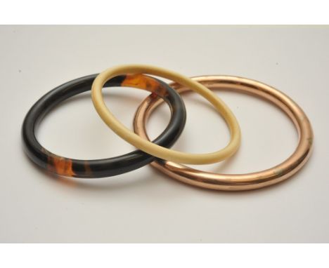 A 9ct gold bangle possible loaded core an ivory bangle and a tortoiseshell bangle (3) 