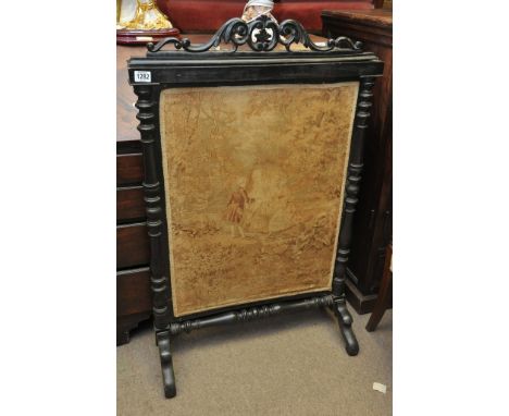 A Victorian fire screen with tapestry panel