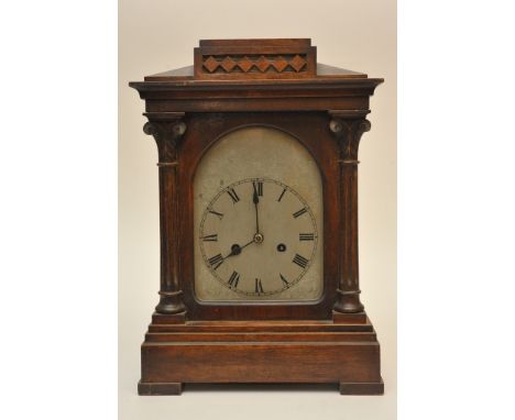 A Classical style oak cased mantle clock with key and pendulum
