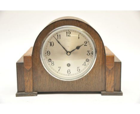 An oak cased mantle clock with silvered dial