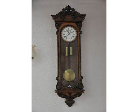 A 19th Vienna wall clock with an enamel dial and double brass weights with applied scroll moulding's