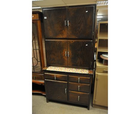 A maid saver kitchen cabinet with enamel top.