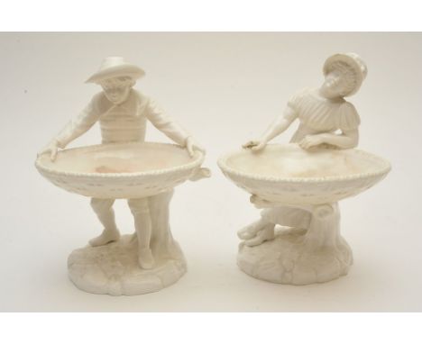 A pair of white glazed Worcester figures holding shallow baskets 