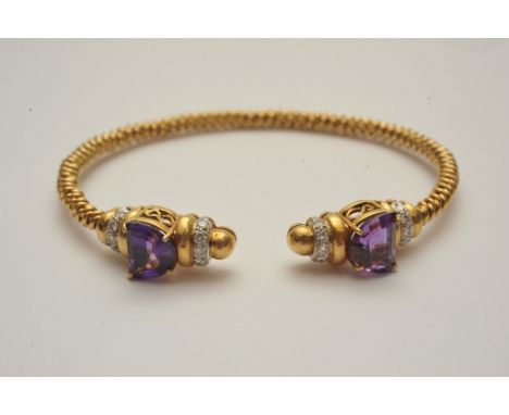 An 18ct gold bangle inset with diamond and amethyst stones 