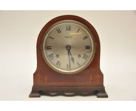 An Edwardian inlaid mahogany mantle clock, the silvered dial marked Parkes & Son Braintree