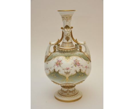 A Royal Worcester twin handled vase with scrolling foliate decoration, raised masks and gilding