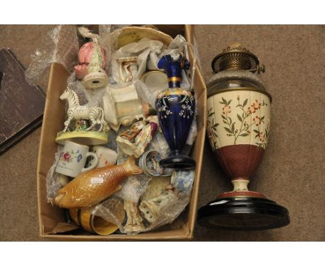 A collection of largely Victorian ceramics including a painted oil lamp, saltglaze fish flask, model of a zebra, figures and 