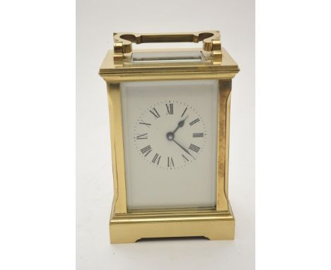 A brass carriage clock, the enamel dial with Roman numerals 