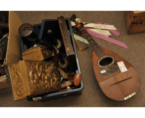 A box of oddments including a mandolin, miner's lamp and clock