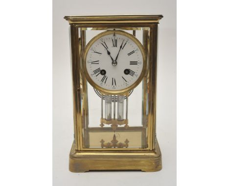 A brass four glass clock the enamel dial with Roman numerals and mercury pendulum 