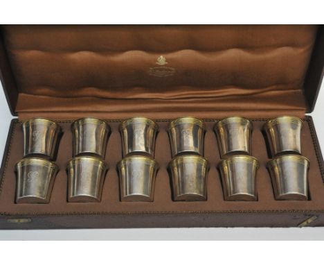 A cased set of 12 K. Anderson silver beakers.