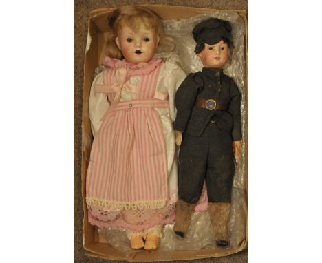 A small German bisque headed girl doll with glass eyes impressed welsch 5/0 and boy doll in suit and hat impressed p 5/0 M he