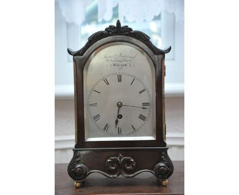 A Scottish early 20th century single fusee bracket clock the case with a shaped top and applied scroll moulding the silvered 